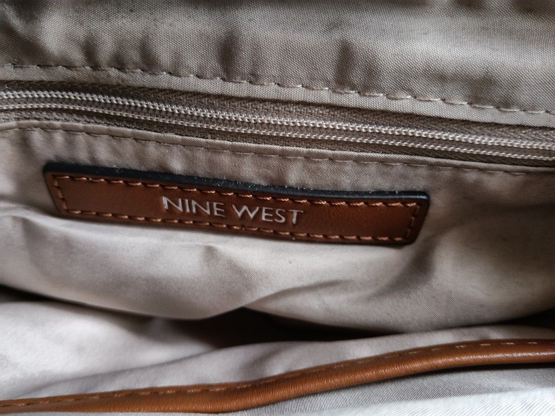 Nine West Monogrammed Satchel Bag (Category: Tote Bags) located in Paranaque City. Submitted by 27rcd (Listing ID 1447206497, Image 3). Description: - Brown Nine West satchel bag - Classic all-over monogram pattern - Tan leather handles and trim - Zipper closure - Detachable shoulder strap included - Interior zip pocket - Ideal for everyday use 11.5" W x 8" H x 4 " D.