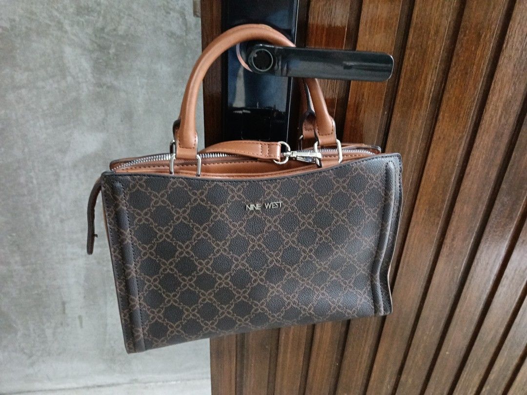 Nine West Monogrammed Satchel Bag (Category: Tote Bags) located in Paranaque City. Submitted by 27rcd (Listing ID 1447206497, Image 2). Description: - Brown Nine West satchel bag - Classic all-over monogram pattern - Tan leather handles and trim - Zipper closure - Detachable shoulder strap included - Interior zip pocket - Ideal for everyday use 11.5" W x 8" H x 4 " D.