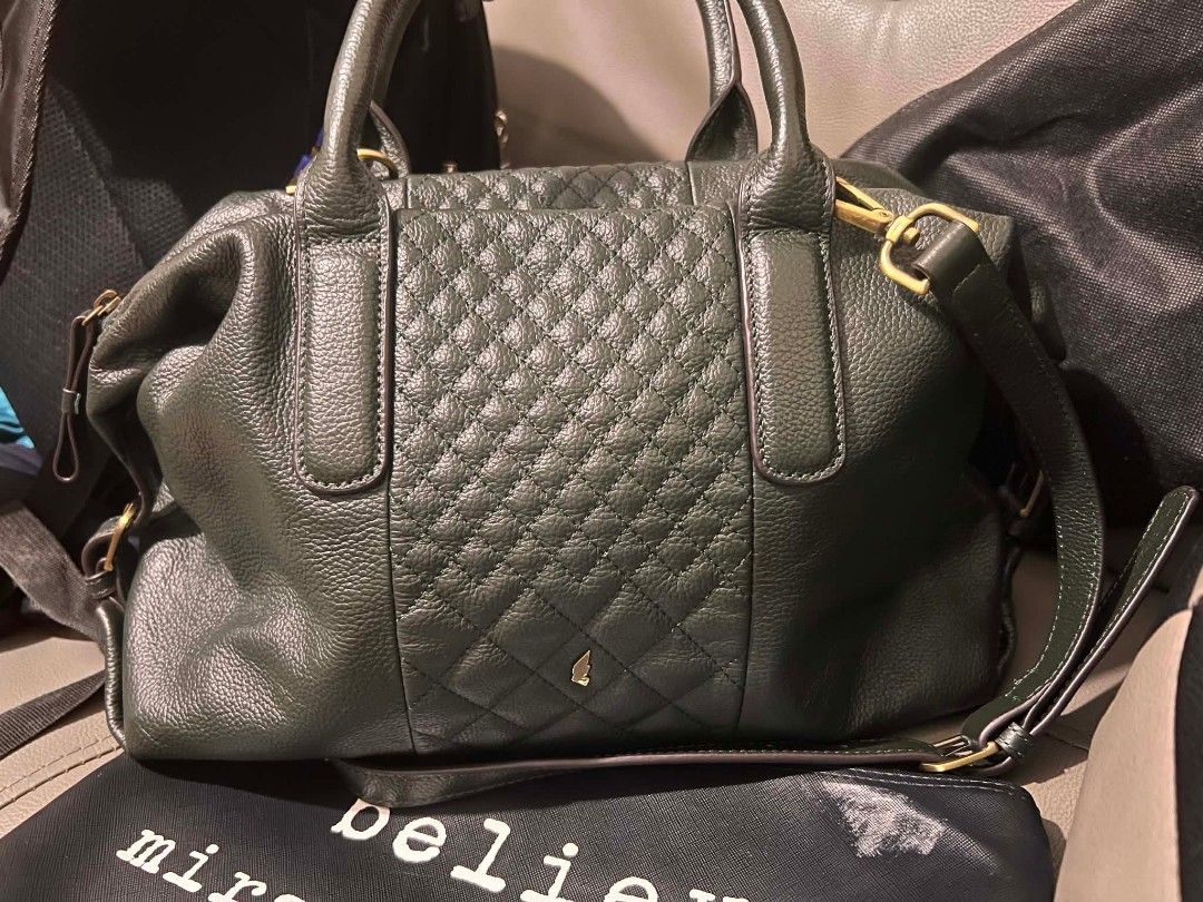 Office bag (Category: Luxury Bags & Wallets) located in Cavite. Submitted by red_2407 (Listing ID 1447227969, Image 1). Description: Olivia Lauren The bag is made of textured leather (often referred to as pebble-grain or Nappa leather) and features a prominent quilted or diamond-stitched pattern on the front panel.Hardware: The visible hardware, such as the strap buckles, appears to be matte gold-tone It is a dark, saturated green with cool under
