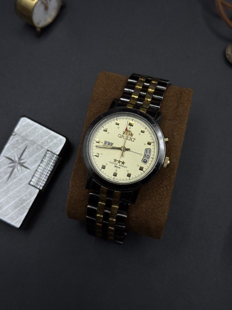 Orient 3 Star Automatic phantom black gold tone Automatic Dater (Category: Men's Watches) located in Pinili. Submitted by thetimecollector (Listing ID 1447286620, Image 1). Description: Black stainless And Gold Tone Phantom 36mm case automatic Newly Serviced July 1, 2026.