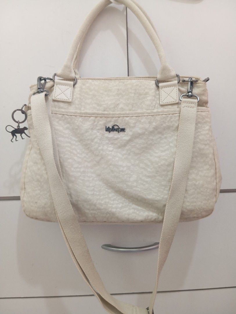 Original Kipling cross body bag (Category: Tote Bags) located in Manila. Submitted by brion123 (Listing ID 1447135780, Image 2). Description: - bought from japan Chic cream Kipling tote bag - Features a subtle leopard print pattern - Comfortable top handles - Includes a detachable shoulder strap for versatility - Multiple interior pockets for excellent organization - Secure zipper closure on top - Ideal for everyday errands or your next getaway.