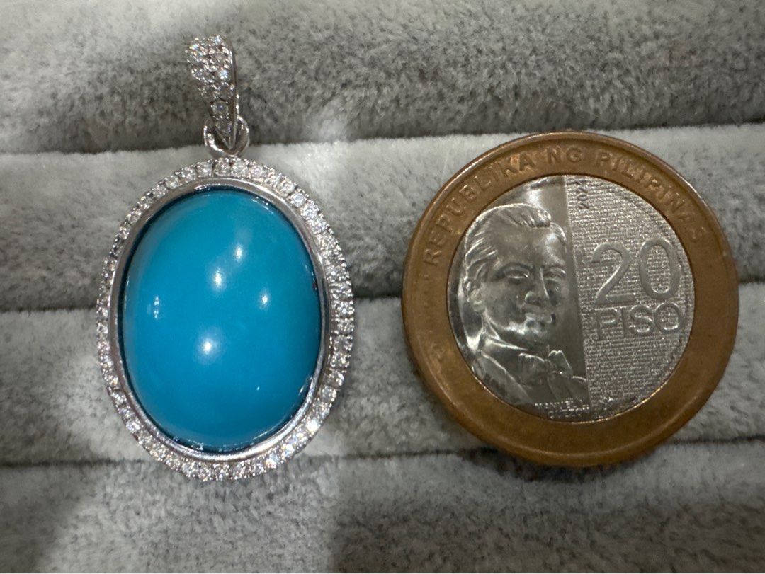 Oval Turquoise Pendant with Diamond Halo (Category: Necklaces) located in Quezon City. Submitted by flowercharm (Listing ID 1447182006, Image 2). Description: - Stunning oval turquoise gemstone pendant - Set in a silver-tone metal - Surrounded by small, sparkling accent stones with moissanite - Bale is also encrusted with stones - Adds a vibrant pop of color to any outfit - Size 18 carat comparable to a 20 Piso coin.