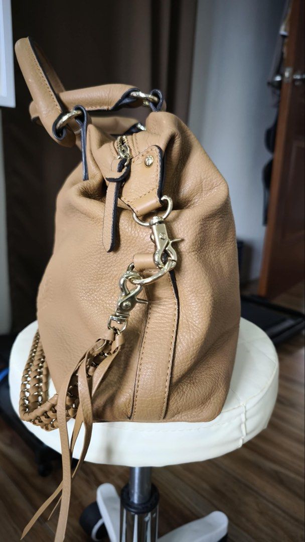 PINN BAKER Leather Handbag Tan (Category: Luxury Bags & Wallets) located in Antipolo. Submitted by waco1313 (Listing ID 1447146570, Image 3). Description: - Tan pebbled leather handbag - Braided side detail - Tassel zipper pulls - Interior with multiple compartments - Patterned lining - Gold hardware - Detachable shoulder strap included.
