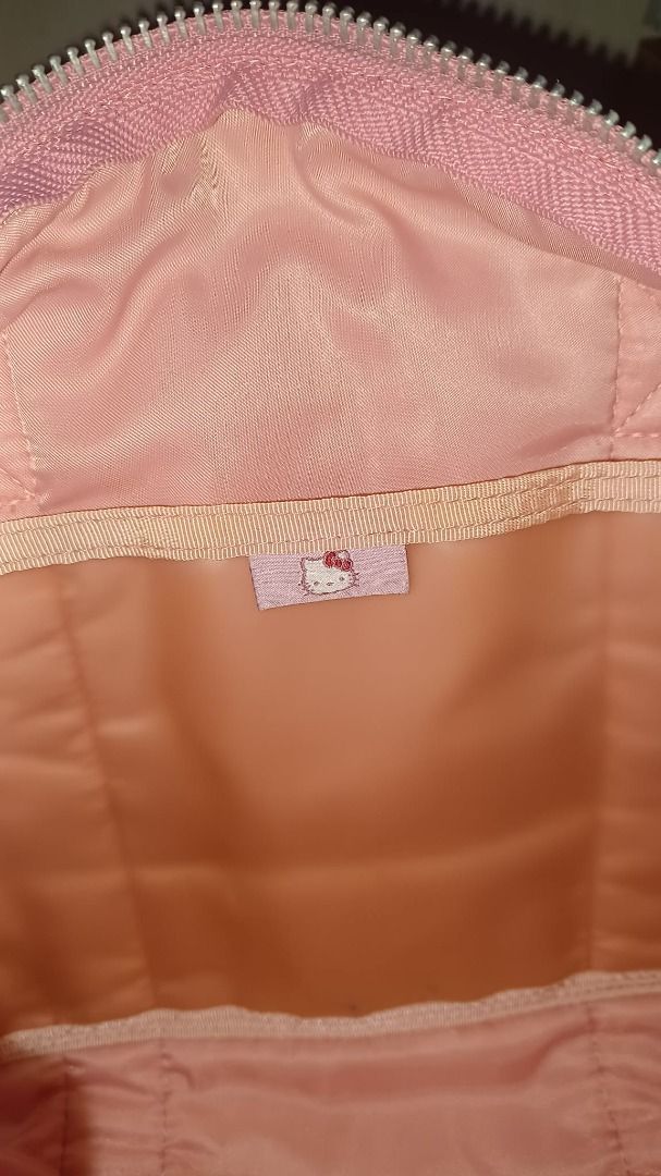 Porter x Hello Kitty Rare Collab Pink Bag (Category: Shoulder Bags) located in Manila. Submitted by missmoneymaker (Listing ID 1447229550, Image 3). Description: - Adorable pink Porter Boston bag - Features a special Kitty 30th anniversary print - Classic Porter logo scattered throughout the design - Equipped with two comfortable top handles - Secure zip closure for your belongings - Ample interior space for essentials - Ideal for travel or every