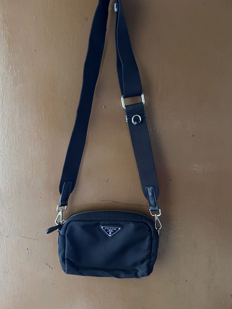 Prada Nylon Crossbody Bag Black (Category: Luxury Bags & Wallets) located in Dipolog. Submitted by adrian281994 (Listing ID 1447132432, Image 1). Description: - Black Prada Nylon Crossbody Bag Kasya wallet cellphone - Adjustable strap for comfortable wear - Secure zipper closure - Compact size, perfect for carrying essentials - Elegant silver hardware details - Modern and sleek design - Versatile for everyday use.