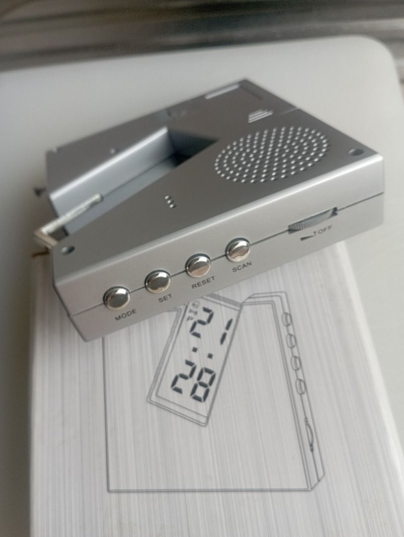 Radio Clock (Category: Clocks) located in Singapore. Submitted by tpdavid (Listing ID 1447215850, Image 3). Description: - Silver radio clock - Displays time and date - Buttons: mode, set, reset, scan - Antenna is extended - Ideal for desk or bedside table.