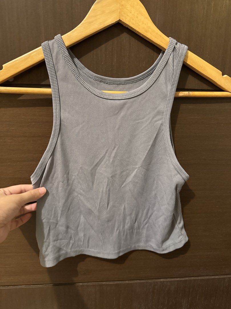 Ribbed Grey Racerback Crop Tank Top (Category: Sleeveless) located in Quezon City. Submitted by ianne.declutter (Listing ID 1447264209, Image 2). Description: bought and used once - Grey ribbed tank top - Cropped length - Racerback design - Stretchy and comfortable material - Versatile for layering or wearing solo - Pairs well with high-waisted bottoms.