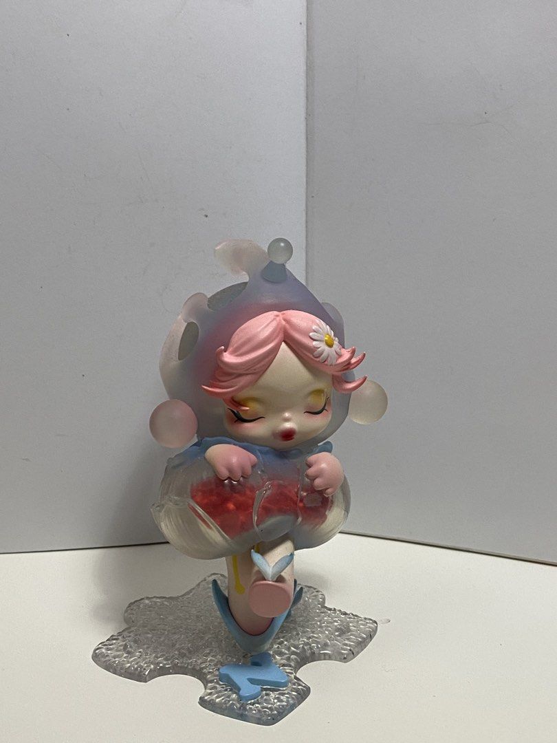skullpanda navigating in dew pop mart (Category: Designer & Blind Box Toys) located in Angeles City. Submitted by hunymoons (Listing ID 1447194059, Image 1). Description: - with bnfc - mint condi Adorable collectible figure - Features a girl with pink hair and a flower accessory - Holding a clear container filled with red berries - Clear, icy base design - Ideal for display or as a gift for collectors - Unique and eye-catching design.