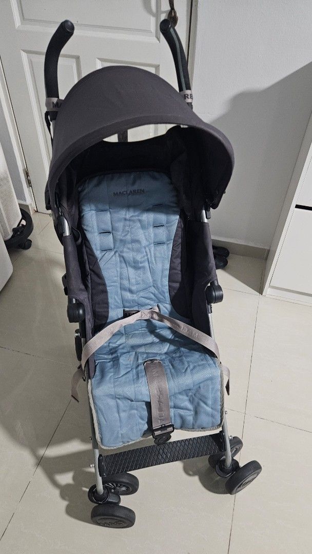 Stroller (Category: Strollers) located in Singapore. Submitted by green_tomcat (Listing ID 1447234749, Image 3). Description: Selling a pre-loved Maclaren stroller, perfect for parents on the go! It features a comfortable padded seat in a lovely blue hue, a generous canopy for sun protection, and easy-to-maneuver wheels. The stroller also comes with a rain cover and the original manual, making it a complete package for your little one. It's super