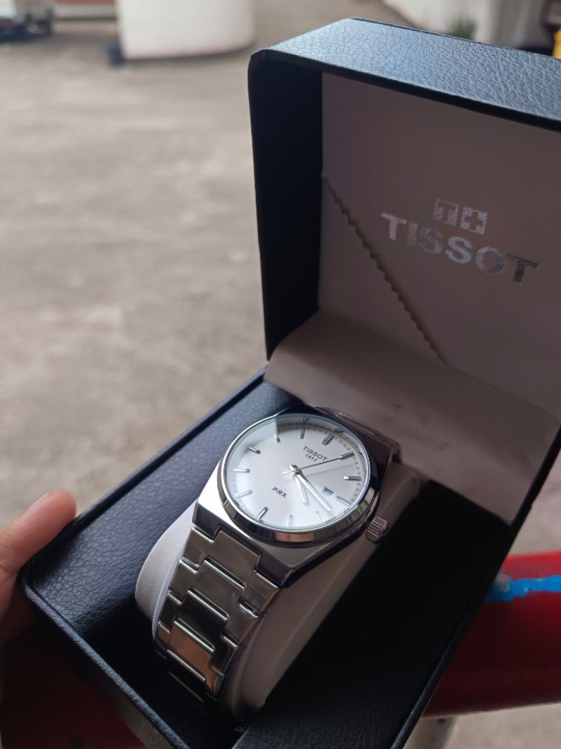 Tissot PRX Watch 1:1 (Category: Luxury Watches) located in Caloocan City. Submitted by seiji09723 (Listing ID 1446086255, Image 1). Description: - Tissot PRX Watch - Classic silver stainless steel design - White dial with date window - Comes with original box and Tissot paper bag - Versatile for everyday wear or special occasions - Feel free to ask questions!.