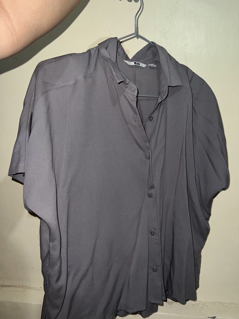 Uniqlo Rayon Short Sleeve Blouse - Gray (Category: Blouses) located in Taytay. Submitted by dezaaaa (Listing ID 1446559727, Image 2). Description: - Brand: Uniqlo - Item: Rayon Short Sleeve Blouse - Color: White - Size: Women's Medium (M) - Material: Soft rayon fabric with a nice drape - Style: Versatile, suitable for casual wear or dressing up - Features: Easy to style with various outfits.
