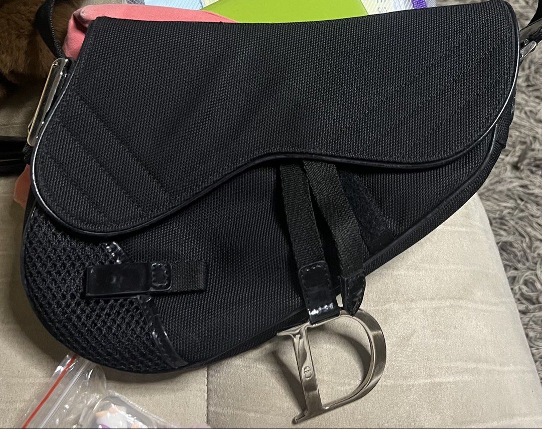 Vintage Dior Black Nylon Saddle Bag (Category: Luxury Bags & Wallets) located in Manila. Submitted by reesesreeses (Listing ID 1447267169, Image 1). Description: - Classic Dior saddle bag - Black nylon fabric - Signature 'D' charm - Mesh detailing on the side - Adjustable strap - Timeless and versatile for everyday use.