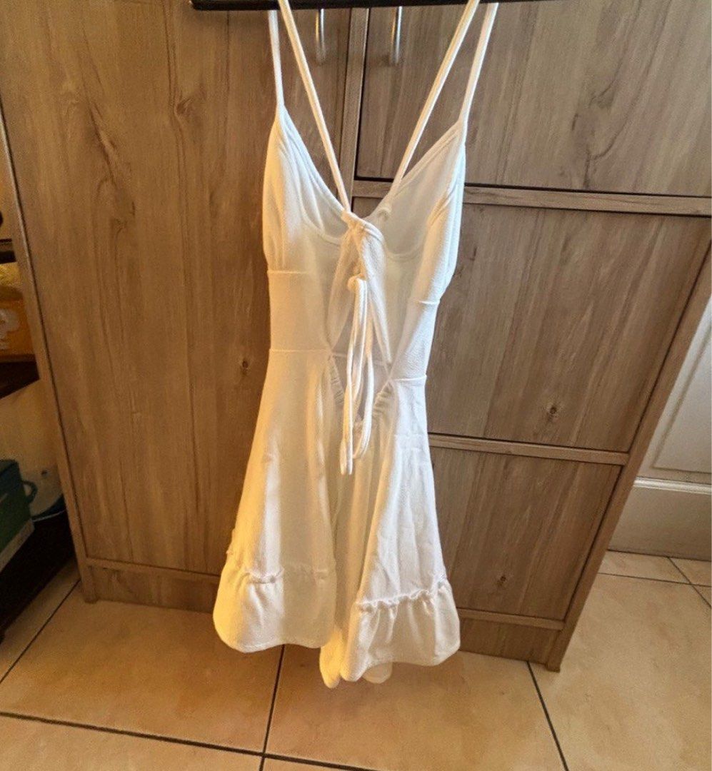 White Halter Neck Mini Dress with Tie Back (Category: Dresses) located in Silang. Submitted by declutterswuni (Listing ID 1447207474, Image 3). Description: - Cute white mini dress - Halter neck with tie-up back - Ruffled hem detail - Ideal for summer or beach vacation - Lightweight and easy to wear/style.