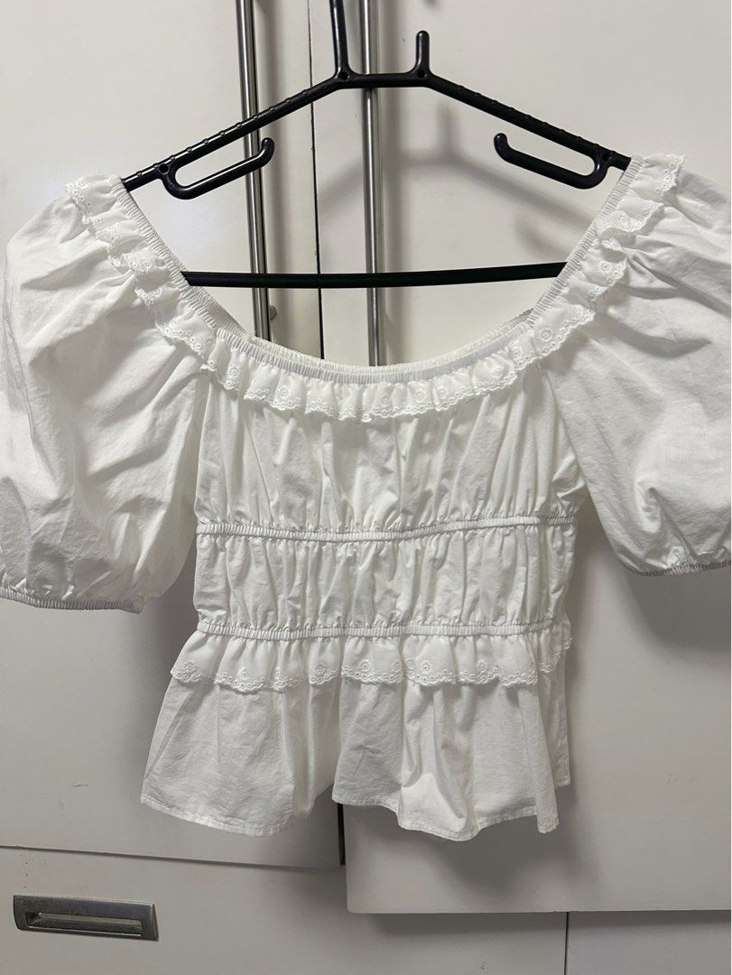 White Puff Sleeve Off-Shoulder Ruffle Crop Top (Category: Blouses) located in Angeles City. Submitted by decluttertime.vela (Listing ID 1447285589, Image 2). Description: - Cute white puff sleeve top - Off-shoulder design with ruffle neckline - Smocked waist for a flattering fit - Tiered ruffle hem - Short sleeves with elastic cuffs - Perfect for casual or dressy occasions - Easily pairs with skirts or shorts.