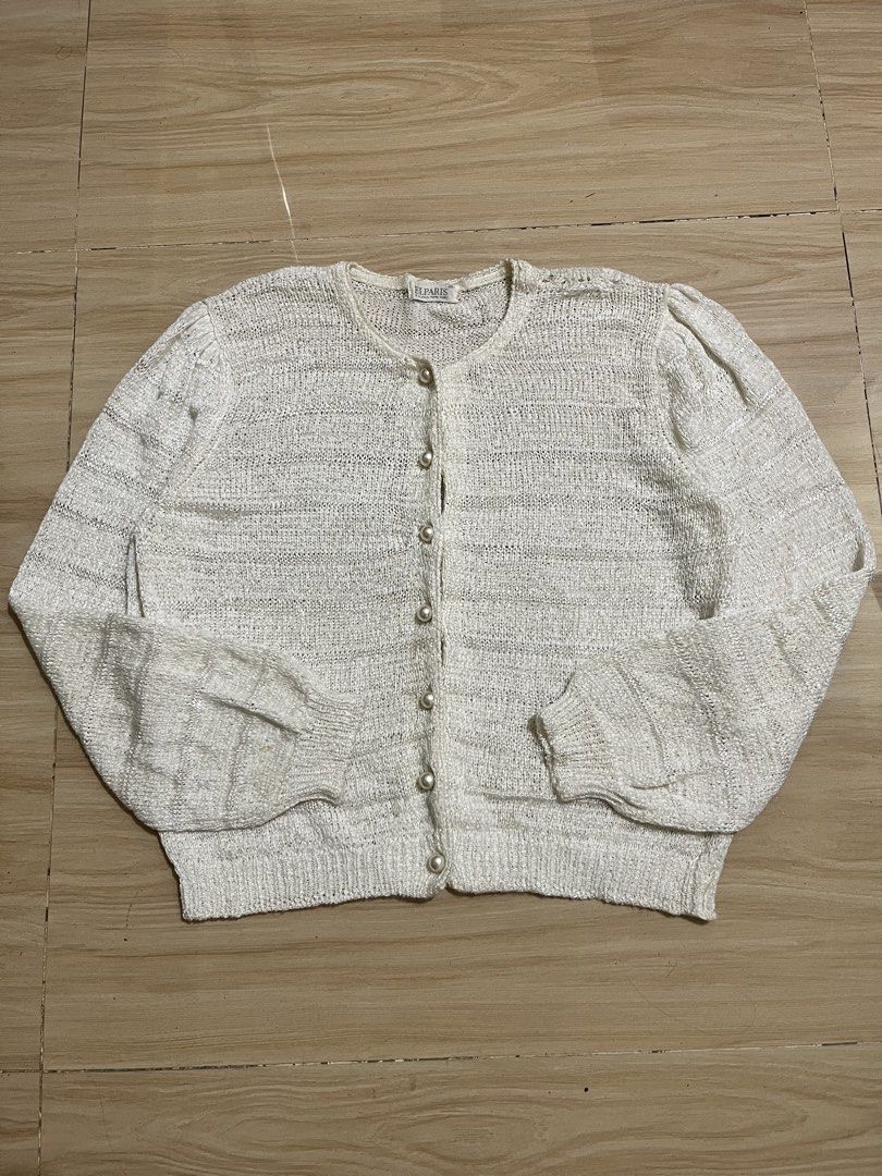White Textured Button-Up Cardigan with Pearl Buttons (Category: Coats, Jackets and Outerwear) located in Manila. Submitted by anline_ (Listing ID 1447183611, Image 1). Description: - White textured knit cardigan - Round neckline - Pearl button closure down the front - Puff sleeves for added detail - Perfect for layering or wearing on its own - A versatile addition to any wardrobe.
