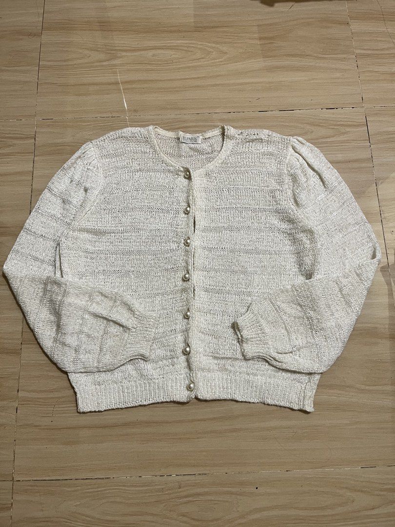 White Textured Button-Up Cardigan with Pearl Buttons (Category: Coats, Jackets and Outerwear) located in Manila. Submitted by anline_ (Listing ID 1447183611, Image 2). Description: - White textured knit cardigan - Round neckline - Pearl button closure down the front - Puff sleeves for added detail - Perfect for layering or wearing on its own - A versatile addition to any wardrobe.