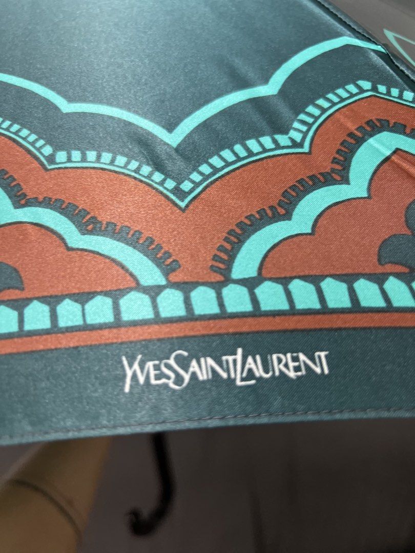 Yves Saint Laurent YSL Dark Green Patterned Umbrella (Category: Umbrellas) located in Las Pinas. Submitted by maple0305 (Listing ID 1447215727, Image 3). Description: - Authentic YSL umbrella - Dark green fabric with unique brown and teal pattern - Classic curved handle - Comes with a matching strap for neat folding - Stylish and practical accessory for rainy days - Perfect for your bag or car.