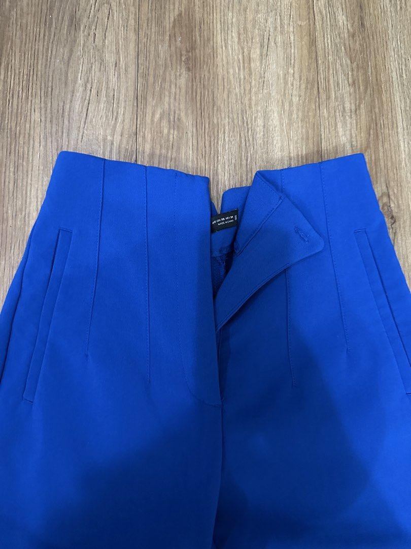 ZARA High Waisted Blue Trousers (Category: Other Bottoms) located in Las Pinas. Submitted by gg_1968 (Listing ID 1447211623, Image 2). Description: - ZARA blue high-waisted trousers - Cropped length - Unique button closure at the front - Side pockets - Versatile for dressing up or down.