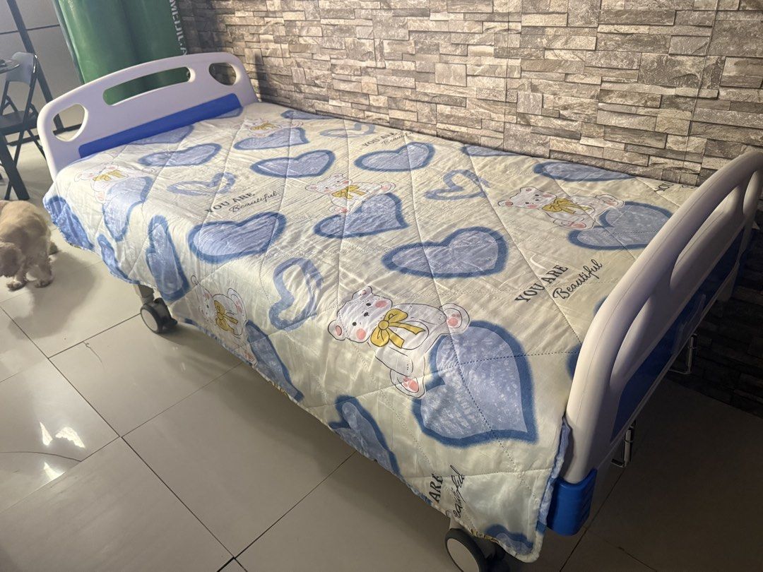 Adjustable Hospital Bed with Wheels and Mattress (Category: Medical Supplies & Tools) located in Antipolo. Submitted by yanniten (Listing ID 1450934776, Image 2). Description: - Adjustable hospital bed - Includes comfortable mattress with cute teddy bear & heart pattern - Equipped with wheels for easy mobility - Sturdy construction for home care needs - Ready for its new home.