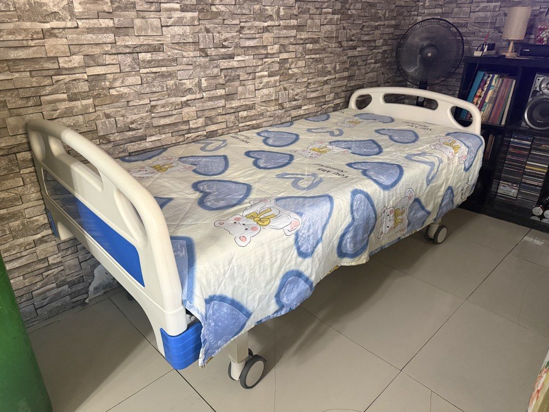Adjustable Hospital Bed with Wheels and Mattress (Category: Medical Supplies & Tools) located in Antipolo. Submitted by yanniten (Listing ID 1450934776, Image 3). Description: - Adjustable hospital bed - Includes comfortable mattress with cute teddy bear & heart pattern - Equipped with wheels for easy mobility - Sturdy construction for home care needs - Ready for its new home.