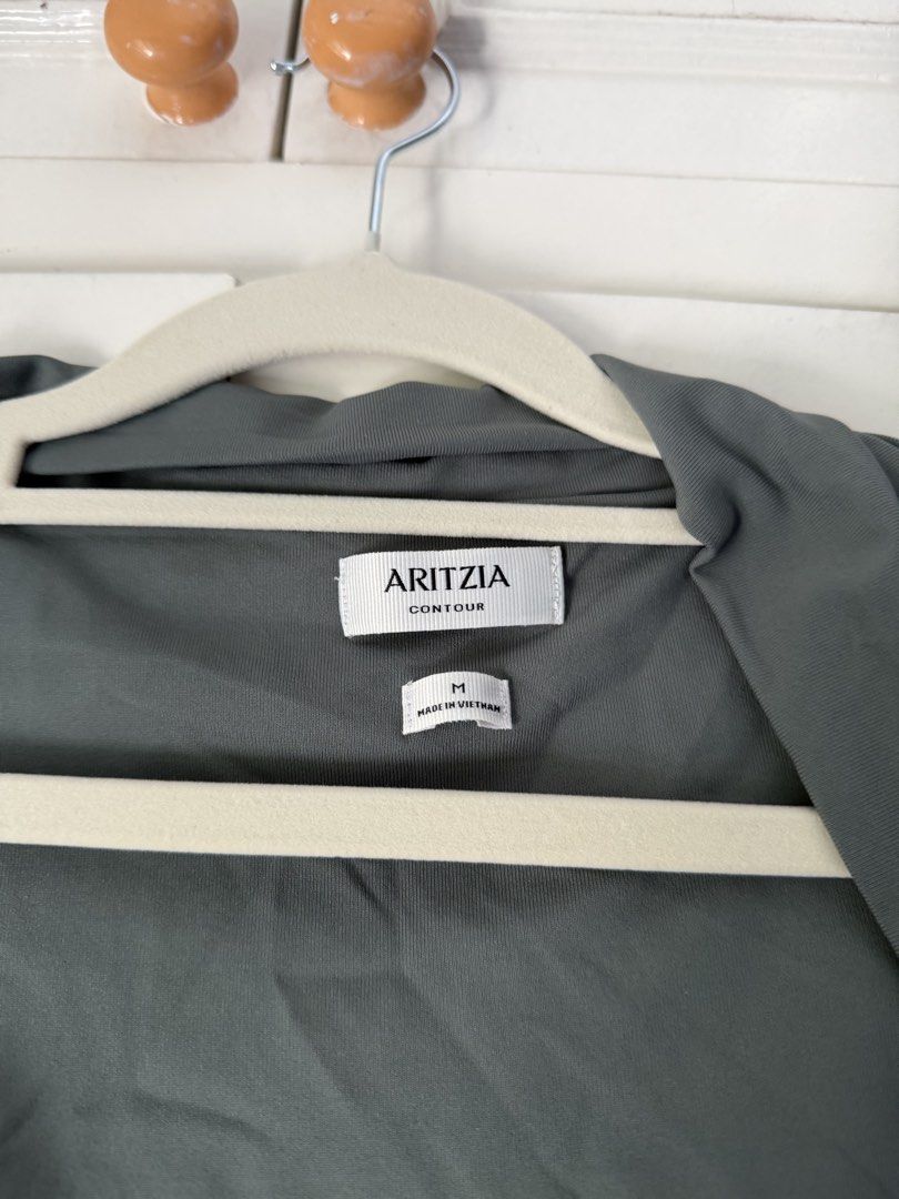 Aritzia Green Casual Flourish Top (Category: Others Tops) located in Muntinlupa City. Submitted by shopmycloset_33 (Listing ID 1450800843, Image 3). Description: Never worn!! Tags are just removed! Model in first photo is wearing a different color RULES All prices are final! No meetups No when worn No returns, No exchanges, No refund What you see is what you get. Happy Shopping 🫶🏻 MOP: GCASH / BPI Shipping: J&T .
