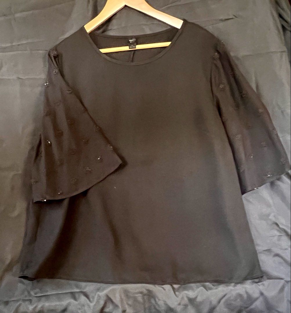 Black Bell Sleeve Top with Embellishments (Category: Blouses) located in Paranaque City. Submitted by cinkydoo (Listing ID 1450776948, Image 1). Description: - Elegant black top - Features bell sleeves with sheer overlay - Chest: 48in - Length: 26in - Delicate dark floral embellishments on sleeves - Classic round neckline - Perfect for dressing up or down - Easily pairs with skirts or pants - Suitable for night outs or casual days.