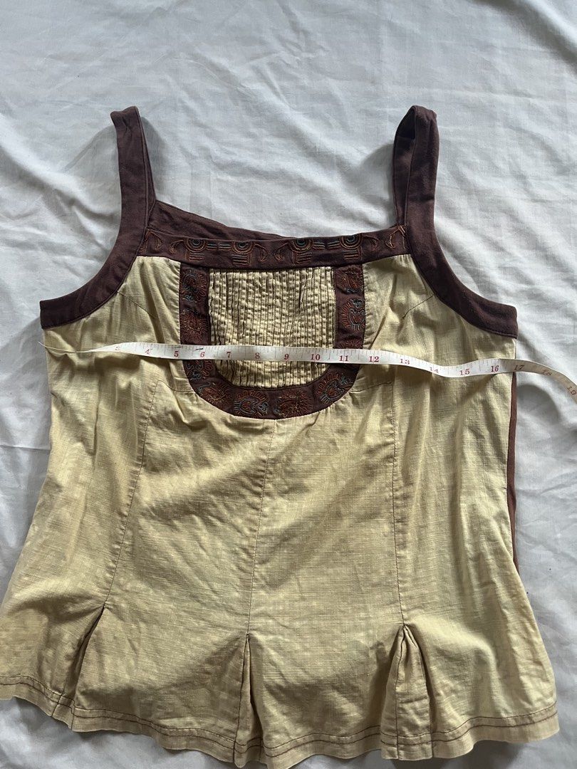 Boho Embroidered Tank Top (Category: Sleeveless) located in Pamplona. Submitted by vjbordon (Listing ID 1450845689, Image 3). Description: Cute tan and brown tank top with embroidered neckline and chest. Features a slight sheen and pleated hem. Perfect for a boho look..