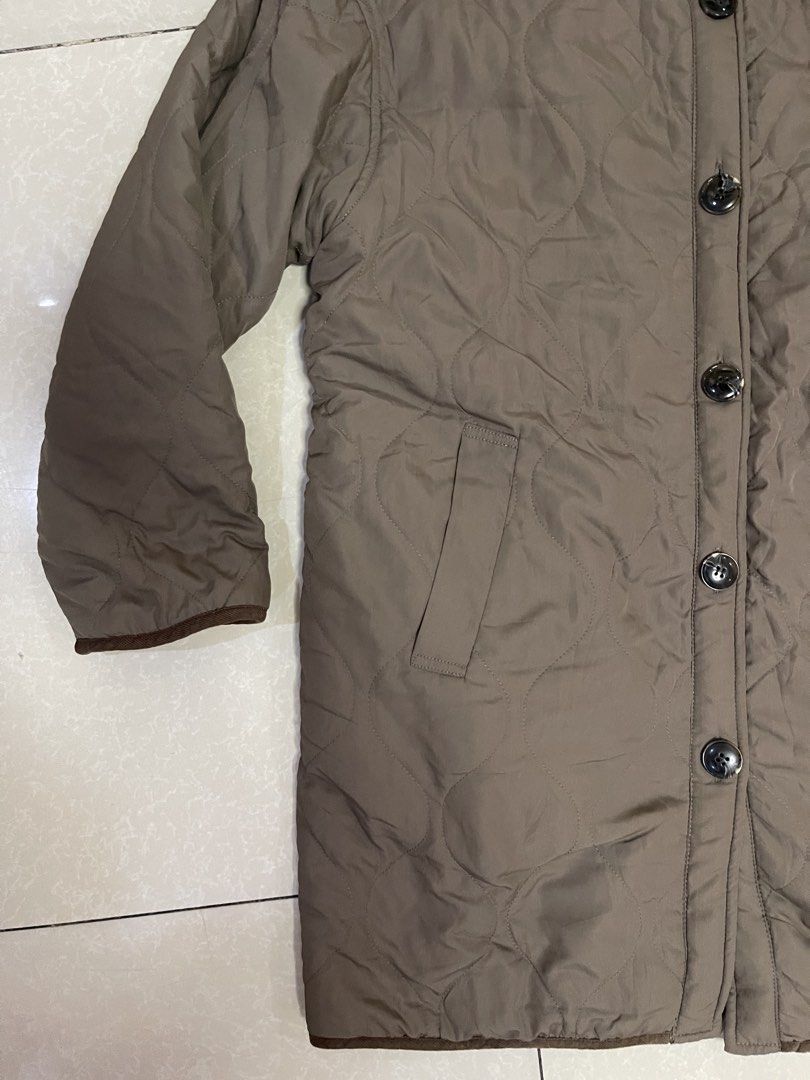 Brown Quilted Button-Up Jacket with Sherpa Lining (Category: Coats, Jackets and Outerwear) located in Manila. Submitted by offtherack_mnl (Listing ID 1450758185, Image 3). Description: - Brown quilted jacket - Cozy sherpa lining - Button-up front - Two side pockets - Brown piping trim on collar - Ideal for layering in cooler weather.
