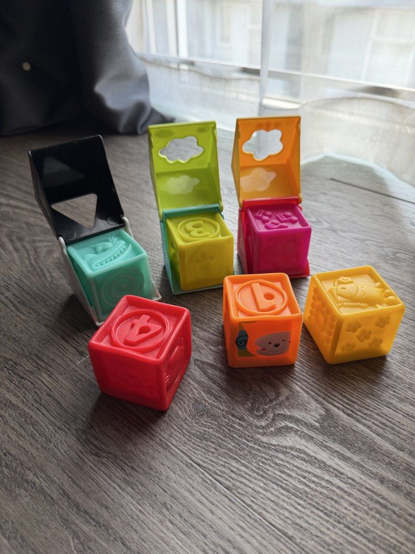 b.toys One Two Squeeze Set Soft Squeeze Silicone Blocks (Category: Infant Playtime) located in Manila. Submitted by onlinegarageph (Listing ID 1450933212, Image 1). Description: - Set of colorful stacking and nesting blocks. - Each block features different animals, letters, or shapes. - Ideal for toddlers to learn and play. Used a few times only .