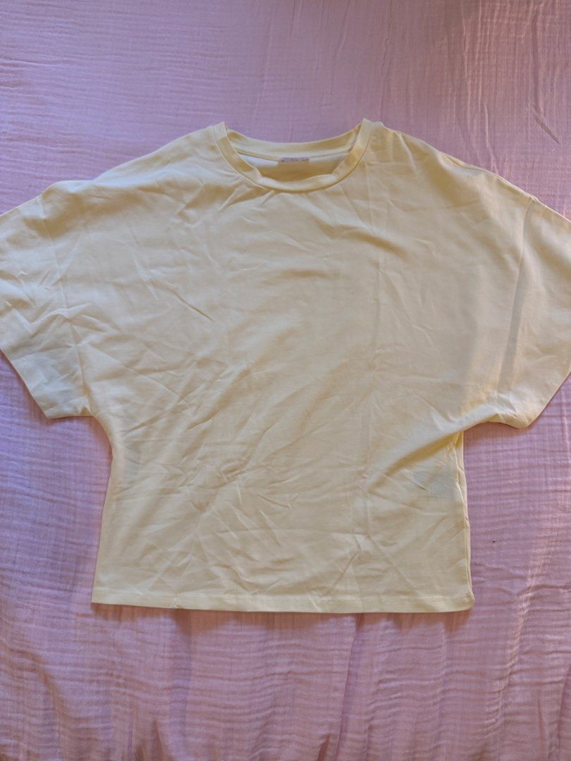 Butter Yellow Oversized T-shirt (Category: Blouses) located in Quezon City. Submitted by helena0413 (Listing ID 1450798228, Image 1). Description: Never worn Tight fit at the bottom - baggy top RFS: looked weird on me.