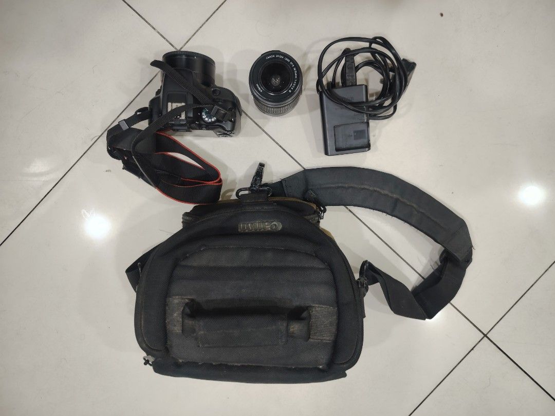 Canon EOS 100D DSLR Camera with Lens and Bag (Category: Cameras) located in Makati City. Submitted by mikerobredillo (Listing ID 1450877124, Image 1). Description: - Canon EOS 100D camera body - Includes Canon lens - Comes with a camera bag - Charger included - Ideal for learning photography - Capable of taking photos and videos - User-friendly and easy to operate.
