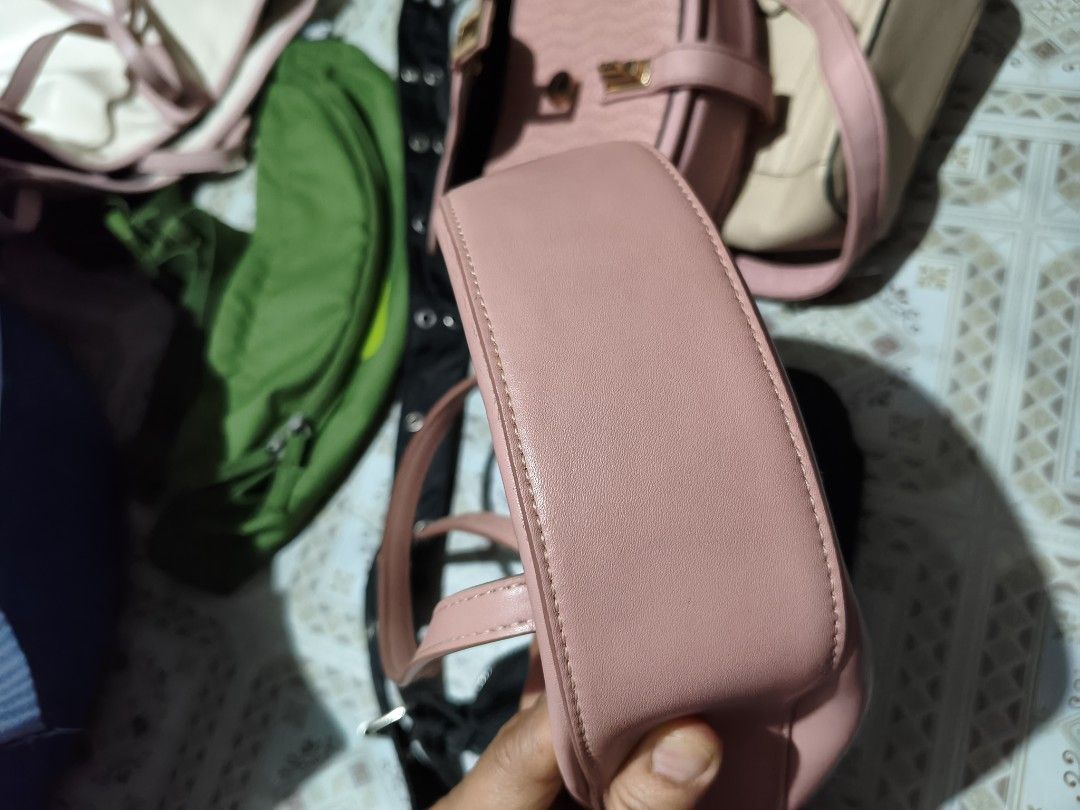 Charles & Keith Pink Top Handle Bag with Clear Handle (Category: Shoulder Bags) located in Quezon City. Submitted by affordable1 (Listing ID 1450897515, Image 2). Description: - Cute pink handbag from Charles & Keith - Features a clear acrylic top handle - Includes a detachable shoulder strap for versatility used✅ check image as is Kung anong nakikita nyo ganyan matayanggap nyo - Interior has multiple compartments for organization - Small, subtle