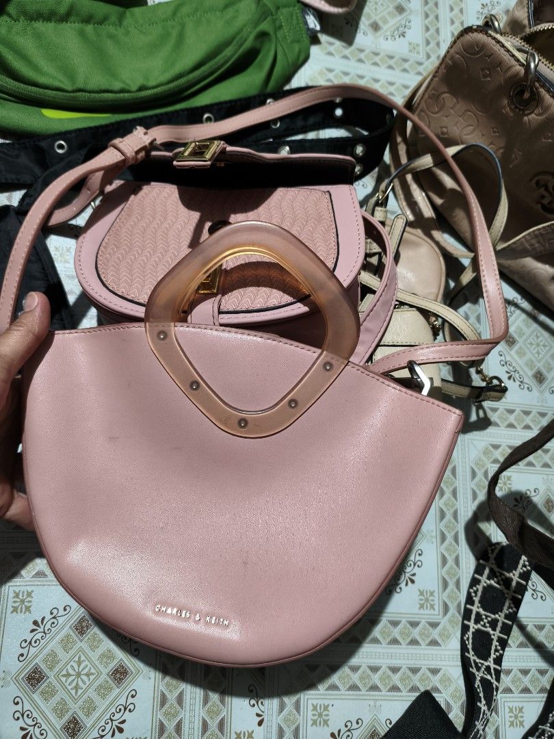 Charles & Keith Pink Top Handle Bag with Clear Handle (Category: Shoulder Bags) located in Quezon City. Submitted by affordable1 (Listing ID 1450897515, Image 1). Description: - Cute pink handbag from Charles & Keith - Features a clear acrylic top handle - Includes a detachable shoulder strap for versatility used✅ check image as is Kung anong nakikita nyo ganyan matayanggap nyo - Interior has multiple compartments for organization - Small, subtle