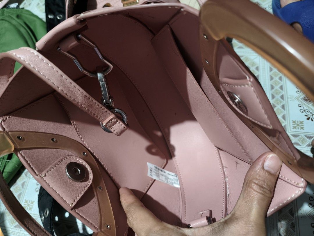 Charles & Keith Pink Top Handle Bag with Clear Handle (Category: Shoulder Bags) located in Quezon City. Submitted by affordable1 (Listing ID 1450897515, Image 3). Description: - Cute pink handbag from Charles & Keith - Features a clear acrylic top handle - Includes a detachable shoulder strap for versatility used✅ check image as is Kung anong nakikita nyo ganyan matayanggap nyo - Interior has multiple compartments for organization - Small, subtle