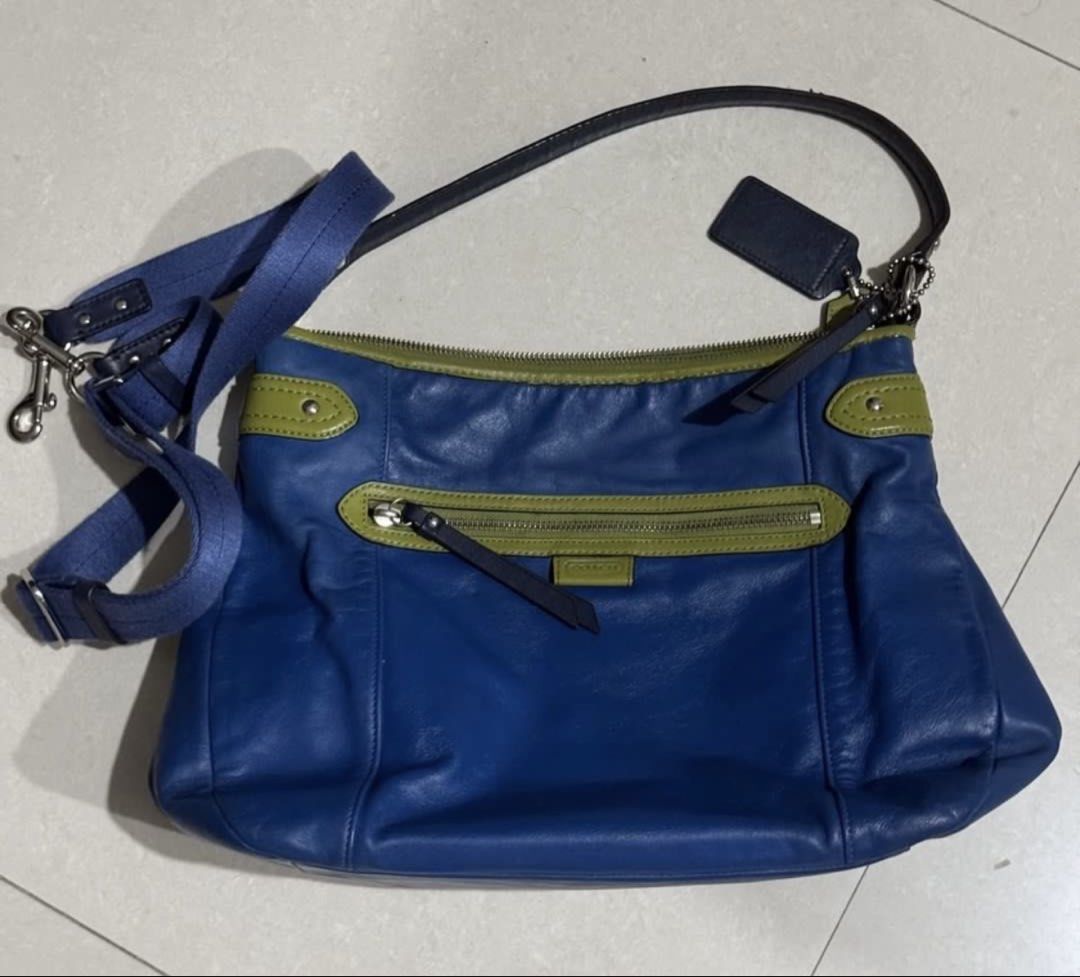 Coach daisy spectator with sling (Category: Cross-body Bags) located in Pasay City. Submitted by taptooload (Listing ID 1450875134, Image 2). Description: Preloved Coach Daisy Spectator Leather Mia Crossbody Hobo EUC Blue leather with olive green details and accents! Soft and smooth! Front zipper pocket, top zipper closure, strap is black and clean! 12” X 10.75” X 4” clean sateen interior! 6” drop shoulder hobo.