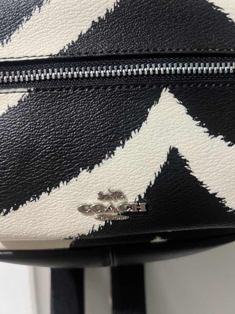 Coach Mini Charlie Backpack (Category: Luxury Bags & Wallets) located in Manila. Submitted by shecuratedit (Listing ID 1450866050, Image 2). Description: - Cute Coach mini backpack - Black and white zebra print design - Front zip pocket for essentials - Adjustable straps for a comfortable fit - Small and compact, ideal for everyday use.