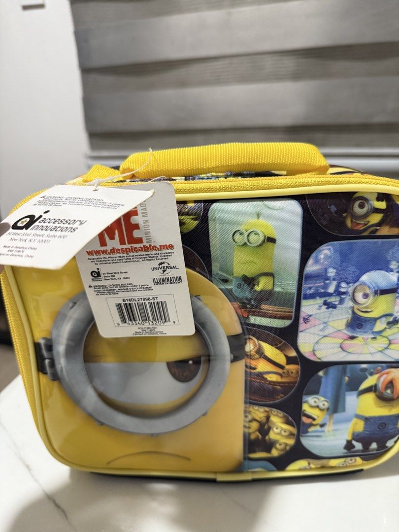 Despicable Me Minions Lunch Bag Accessory Innovations (Category: Babies & Kids Fashion) located in Antipolo. Submitted by jackiestash2 (Listing ID 1450868873, Image 3). Description: - Fun yellow lunch bag featuring various Minions - Large Minion eye graphic on the front - Zipper closure with two pull tabs for easy opening - Convenient top handle for carrying - Made by Accessory Innovations - Ideal for kids' school lunches or outings Antipolo Gcas