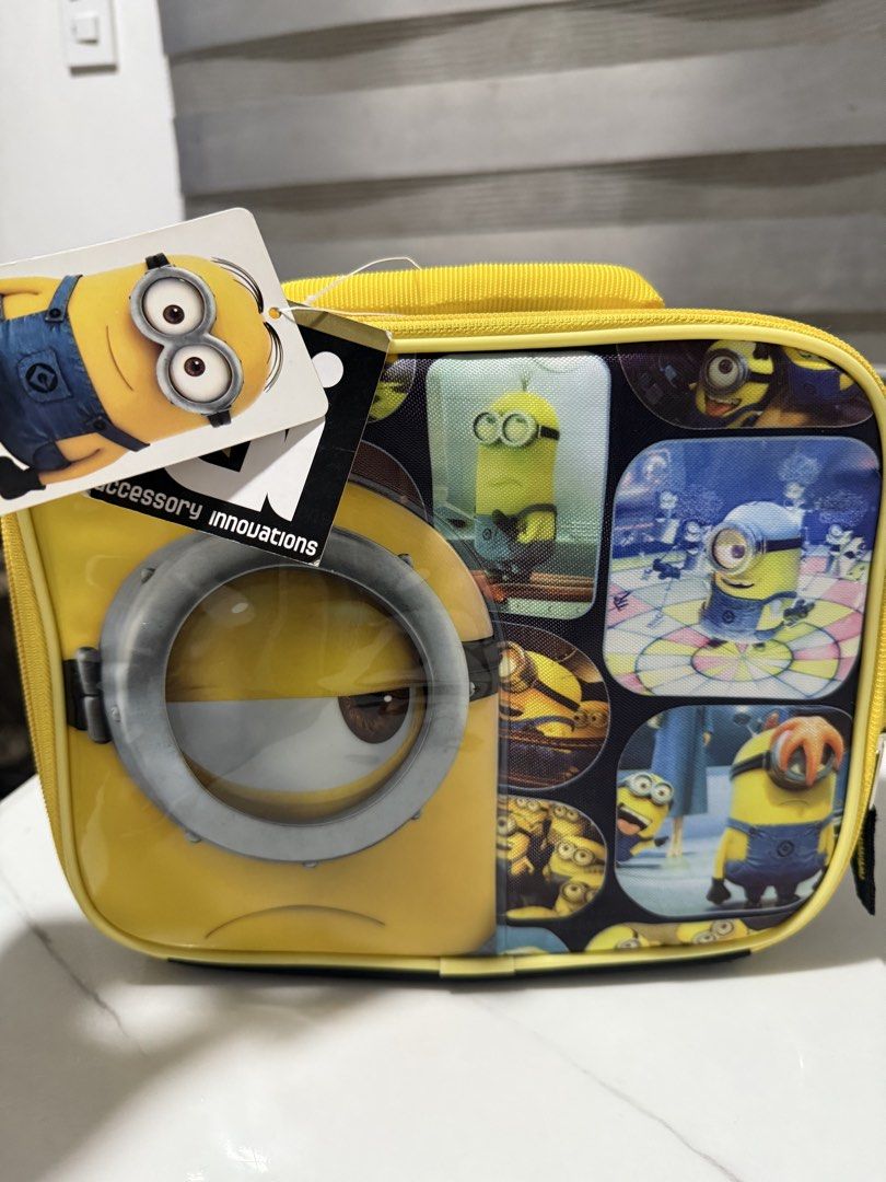 Despicable Me Minions Lunch Bag Accessory Innovations (Category: Babies & Kids Fashion) located in Antipolo. Submitted by jackiestash2 (Listing ID 1450868873, Image 2). Description: - Fun yellow lunch bag featuring various Minions - Large Minion eye graphic on the front - Zipper closure with two pull tabs for easy opening - Convenient top handle for carrying - Made by Accessory Innovations - Ideal for kids' school lunches or outings Antipolo Gcas