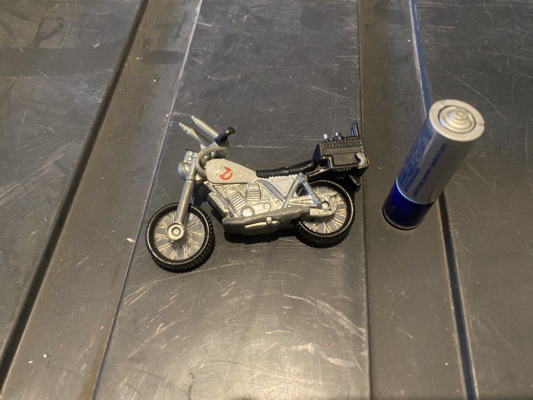 Ghostbusters Ecto-1 Motorcycle Toy (Category: Vehicle & Diecast Models) located in Marikina City. Submitted by jtv17 (Listing ID 1450775631, Image 1). Description: Miniature Ghostbusters motorcycle, Ecto-1 style. Features Ghostbusters logo and rear storage box. Perfect for collectors and fans!.