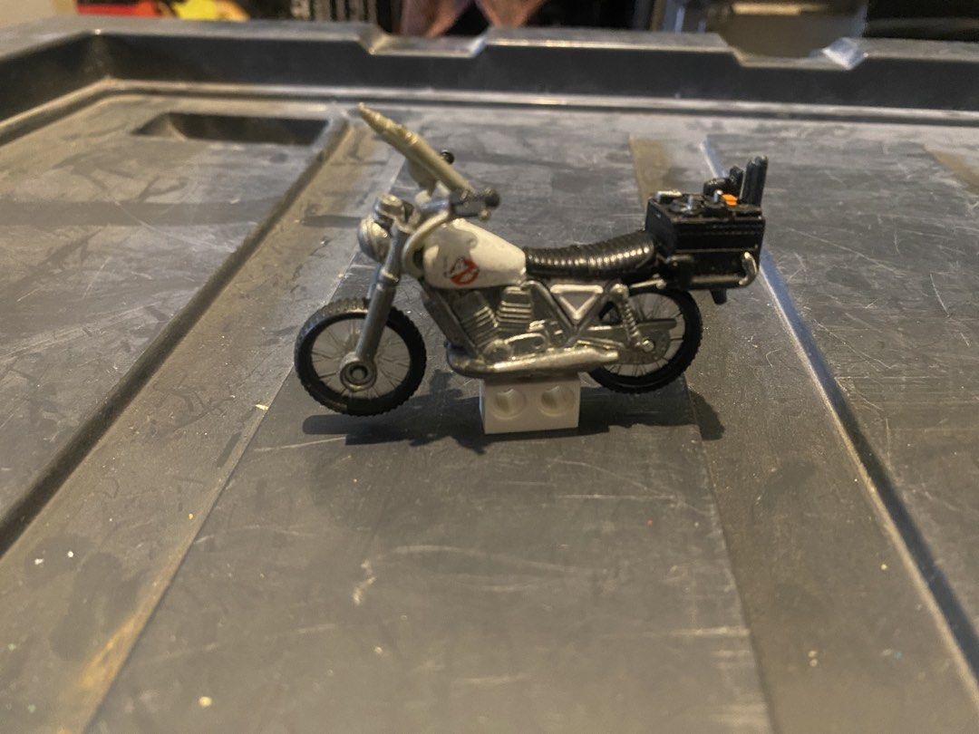 Ghostbusters Ecto-1 Motorcycle Toy (Category: Vehicle & Diecast Models) located in Marikina City. Submitted by jtv17 (Listing ID 1450775631, Image 2). Description: Miniature Ghostbusters motorcycle, Ecto-1 style. Features Ghostbusters logo and rear storage box. Perfect for collectors and fans!.