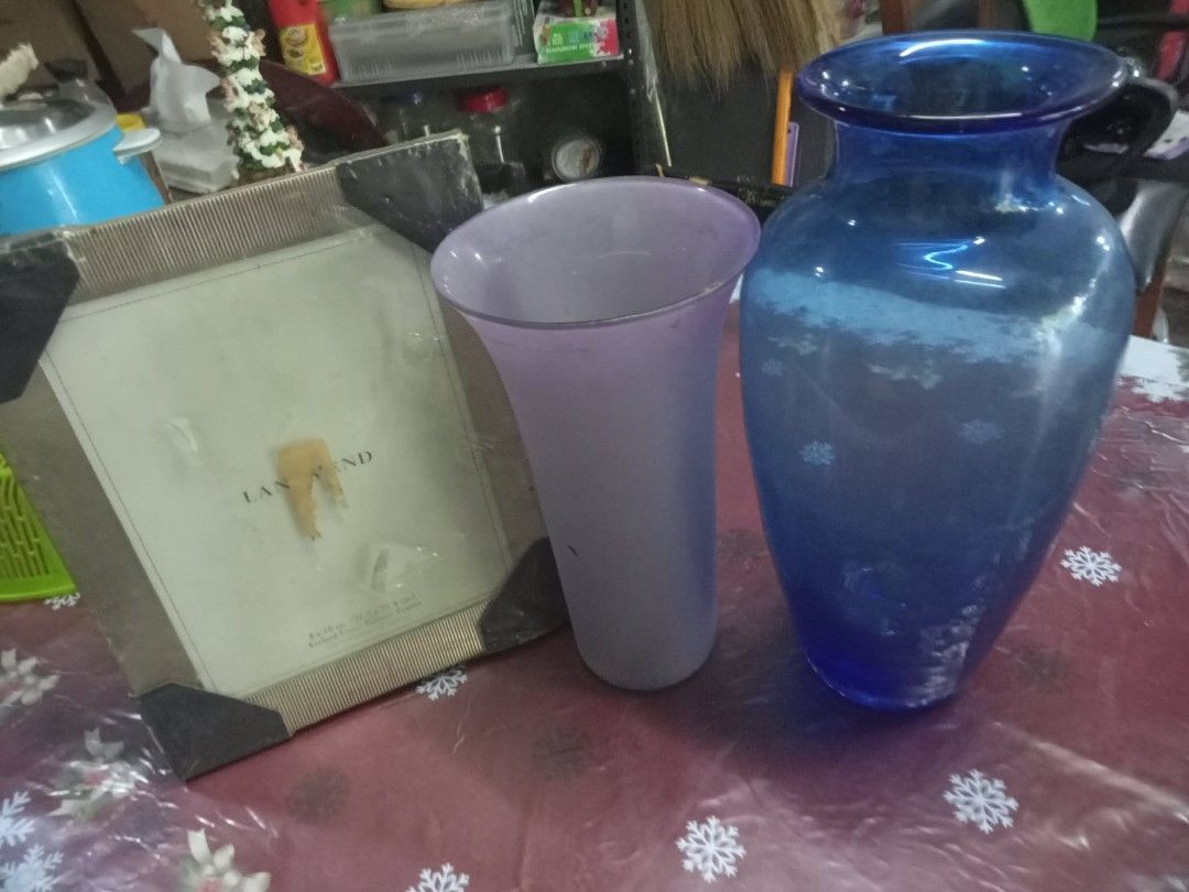 Glass Vases and Picture Frame Set (Category: Vases & Decorative Bowls) located in Quezon City. Submitted by madelrivera (Listing ID 1450740498, Image 1). Description: - Bundle deal: 2 glass vases + 1 picture frame - Tall vase: Deep blue - Short vase: Frosted purple - Picture frame: Neutral beige with black corner protectors - Ideal for home decor.