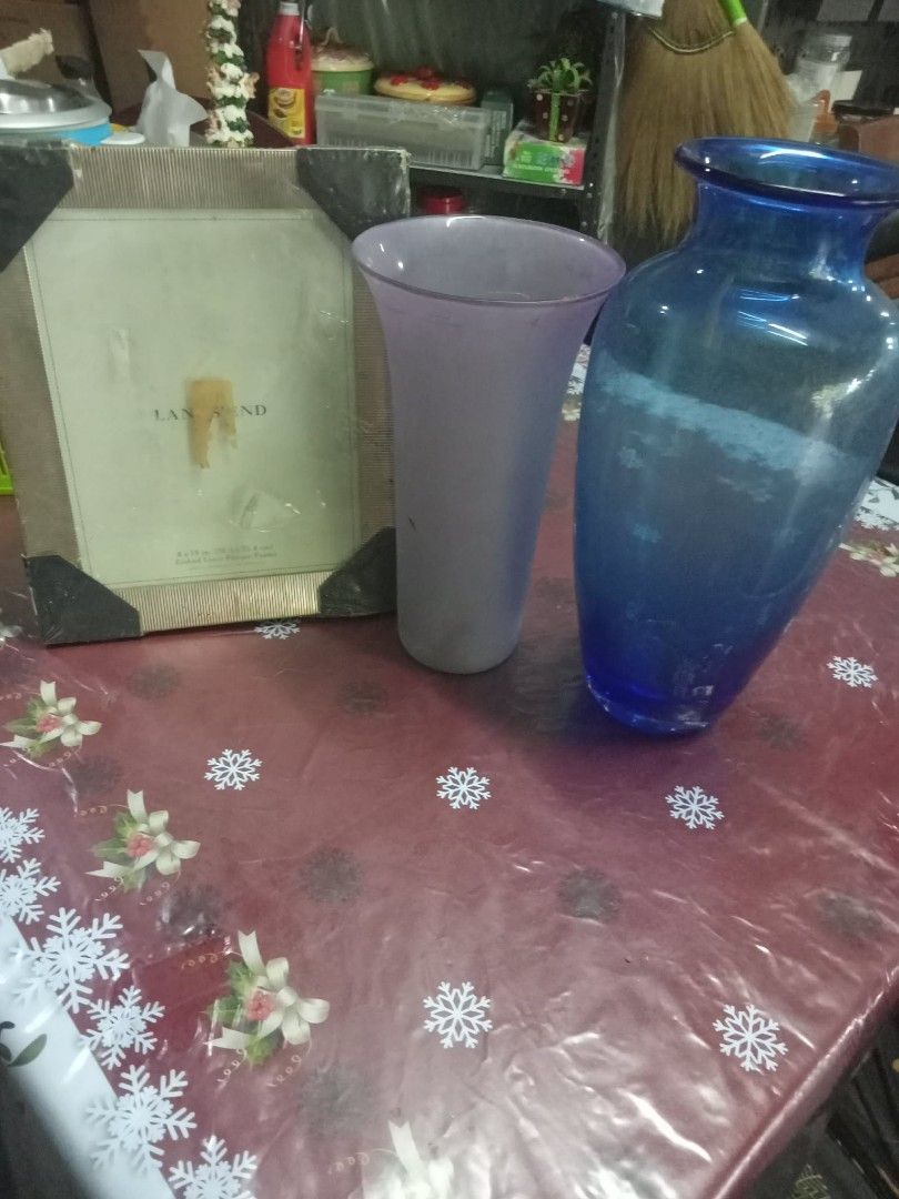 Glass Vases and Picture Frame Set (Category: Vases & Decorative Bowls) located in Quezon City. Submitted by madelrivera (Listing ID 1450740498, Image 2). Description: - Bundle deal: 2 glass vases + 1 picture frame - Tall vase: Deep blue - Short vase: Frosted purple - Picture frame: Neutral beige with black corner protectors - Ideal for home decor.