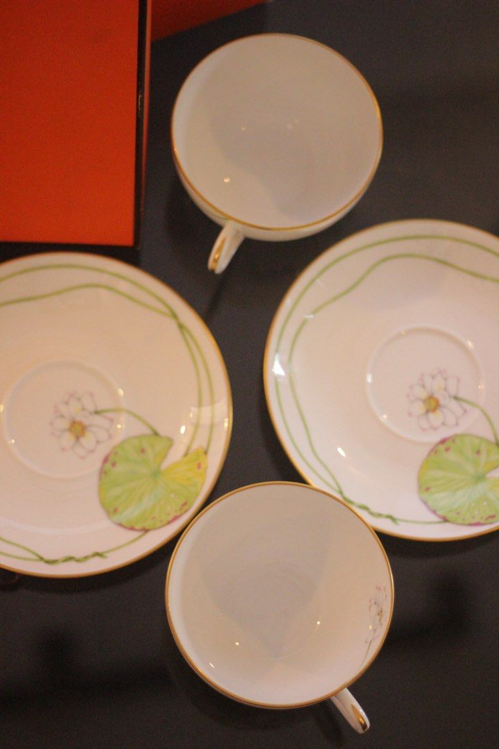 Hermes Tea Cup Nil Collection (Category: Coffee & Tea Tableware) located in Quezon City. Submitted by maria___x (Listing ID 1450780785, Image 3). Description: - Set of 2 authentic Hermes tea cups and saucers. - Elegant lotus flower and lily pad design. - Comes with original Hermes box and ribbon. - Crafted from high-quality porcelain. - Adds a luxurious touch to your tea time. - Ideal gift for tea enthusiasts..