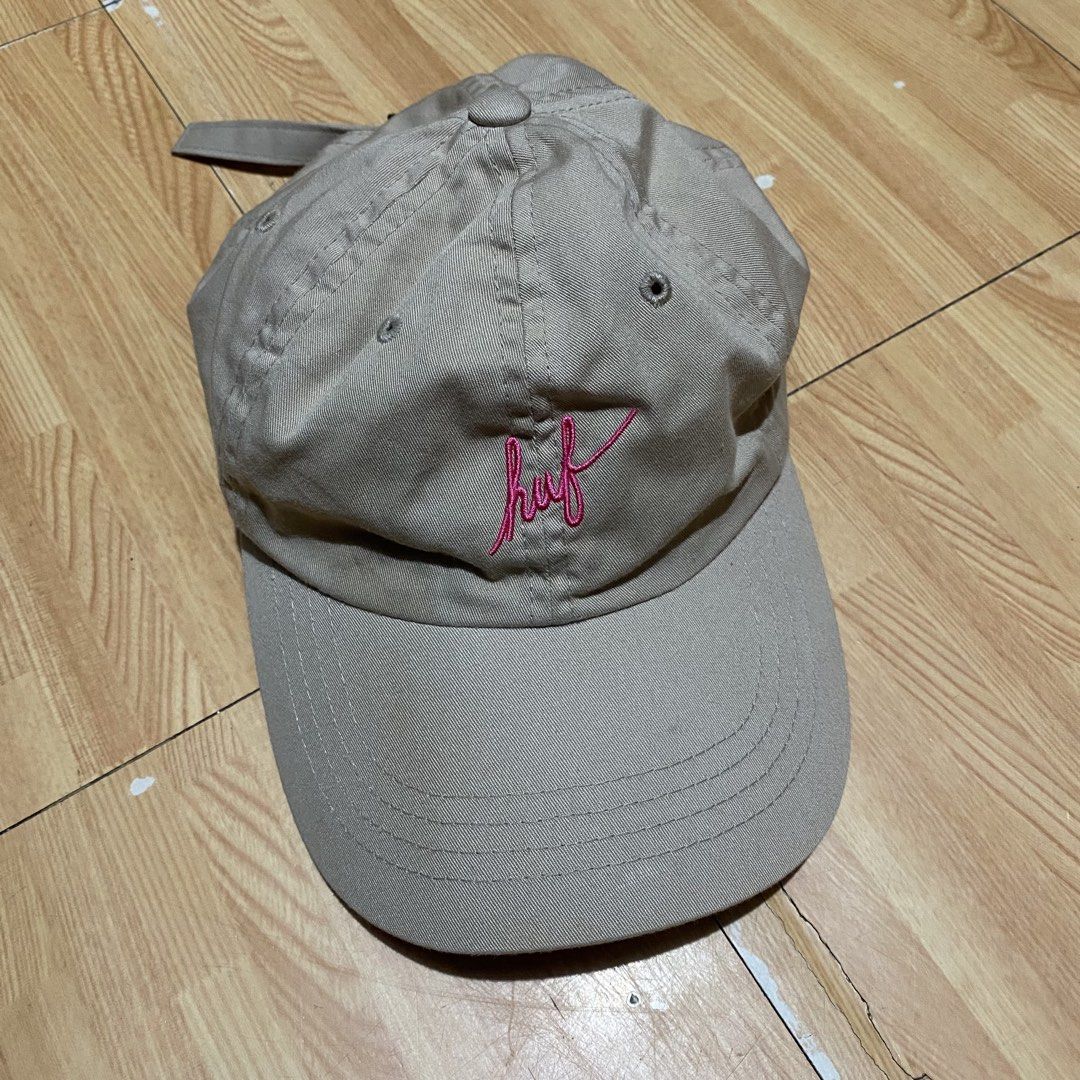 Huf Script Curve Visor 6 Panel Cap - Khaki (Category: Caps & Hats) located in Manila. Submitted by killthismane (Listing ID 1450919110, Image 2). Description: This is a HUF Script Curve Visor 6 Panel Cap in khaki, featuring a distinctive embroidered pink logo on the front. Need Wash.
