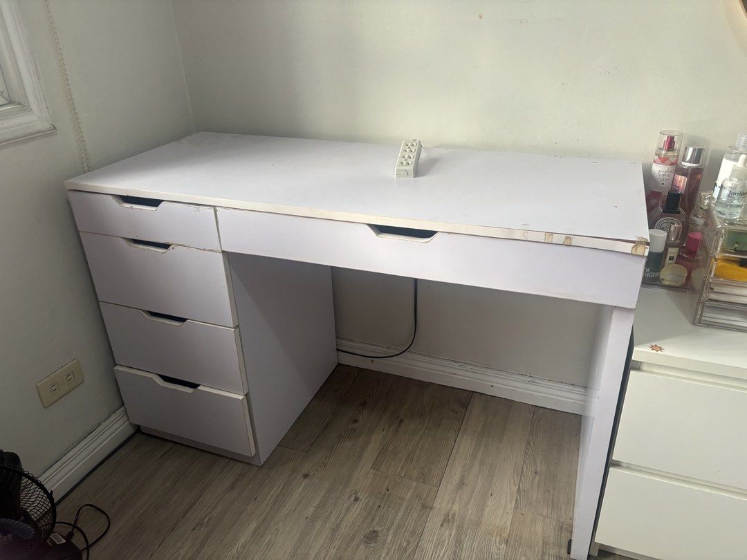Ikea Inspired Alex Desk Table with Drawers (Category: Tables & Sets) located in Taguig. Submitted by prelovedbyla08 (Listing ID 1450766803, Image 1). Description: - Custom Made - 120x50 -White desk with generous surface area - Storage: 3 drawers on the left, 1 large drawer on the right - Condition: Minor wear on tabletop edge, can be fixed by glue - Drawers are in complete good condition - Ideal for: Vanity table or study desk.
