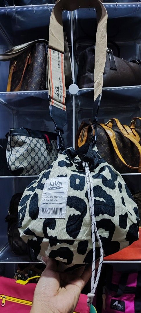 JAVA Leopard Print Drawstring Bucket Bag (Category: Cross-body Bags) located in Machang. Submitted by yie_bundle (Listing ID 1450891339, Image 1). Description: - Cute leopard print drawstring bag from JAVA. - Features a wide strap with JAVA branding. - Unique cinched shape when closed. - Ideal for everyday use or travel. - Spacious interior for your essentials. - Secure drawstring closure. - Includes a convenient shoulder strap..