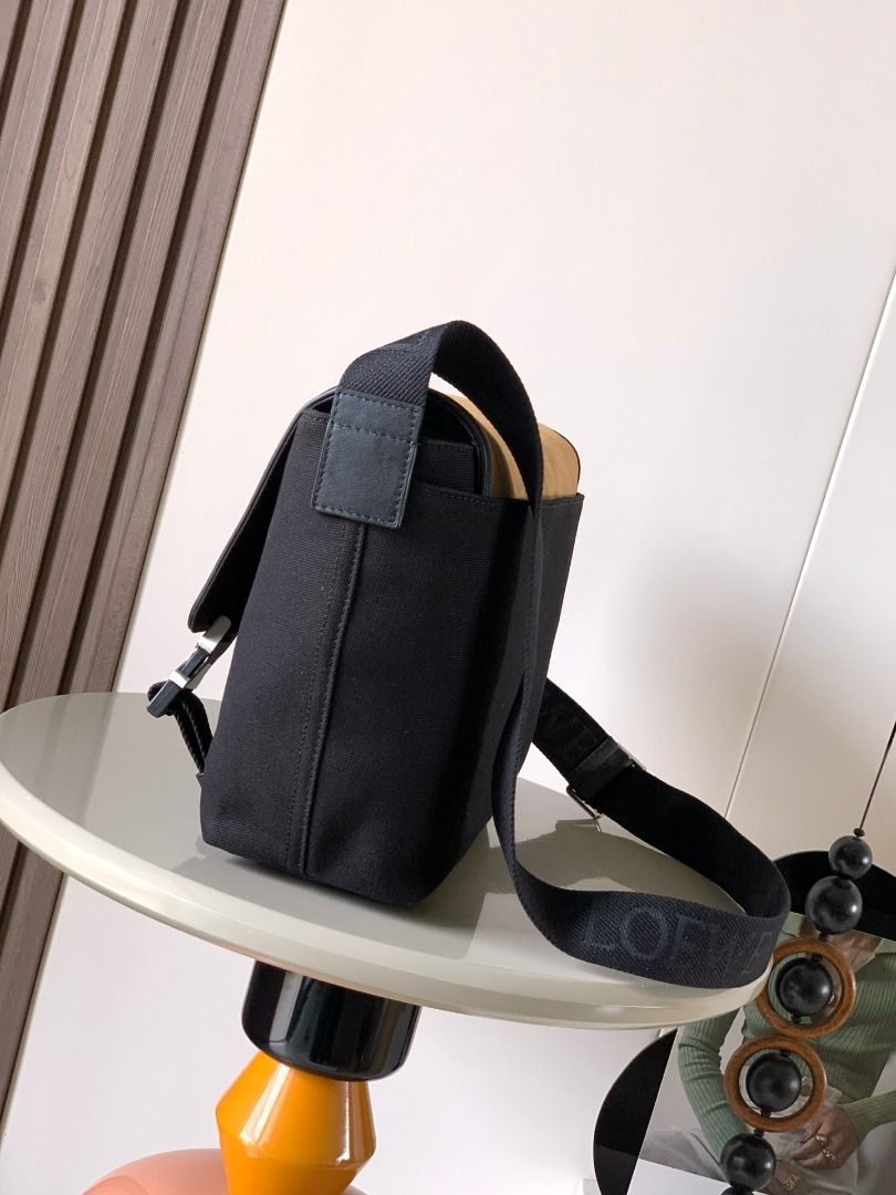 Loewe Black Canvas & Tan Suede Messenger Bag (Category: Luxury Bags & Wallets) located in Caloocan City. Submitted by lindyvanjk96455 (Listing ID 1450807616, Image 2). Description: - Loewe messenger bag - Color: Black canvas body with tan suede flap - Details: Silver buckle accents on the front - Strap: Adjustable shoulder strap with Loewe branding - Features: Zippered pocket on the flap, D-ring detail on front patch - Ideal for: Everyday use.