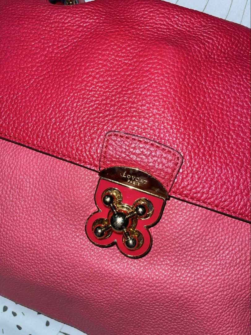 Lovcat Paris Pink Leather Handbag (Category: Luxury Bags & Wallets) located in Manila. Submitted by cosmicrabbit-9e5b (Listing ID 1450787449, Image 2). Description: - Lovcat Paris handbag in a charming pink color. - Textured leather exterior for a sophisticated look. - Unique gold clasp closure for secure and stylish fastening. - Interior includes a zippered pocket for essentials. - Lined with smooth satin featuring the Lovcat logo. - Convenient 