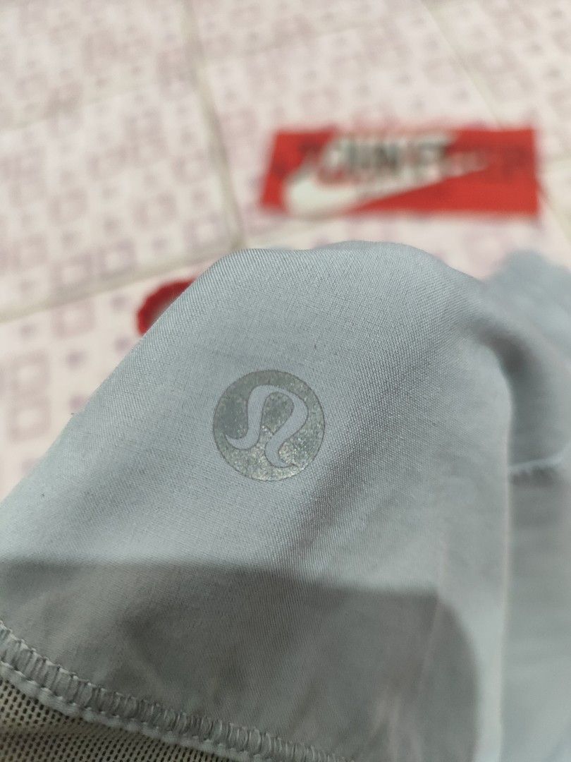 Lululemon Running Shorts Grey Blue Red Trim (Category: Activewear) located in Tuguegarao City. Submitted by johnpetera0818 (Listing ID 1450770861, Image 3). Description: - 24-32 waist 9.5 front 11.5 back Lightweight Lululemon running shorts - Color: Grey with blue and red trim details - Features an elastic waistband - Includes a small zippered pocket on the back - Built-in liner for comfort and support - Ideal for running, workouts, or everyday c