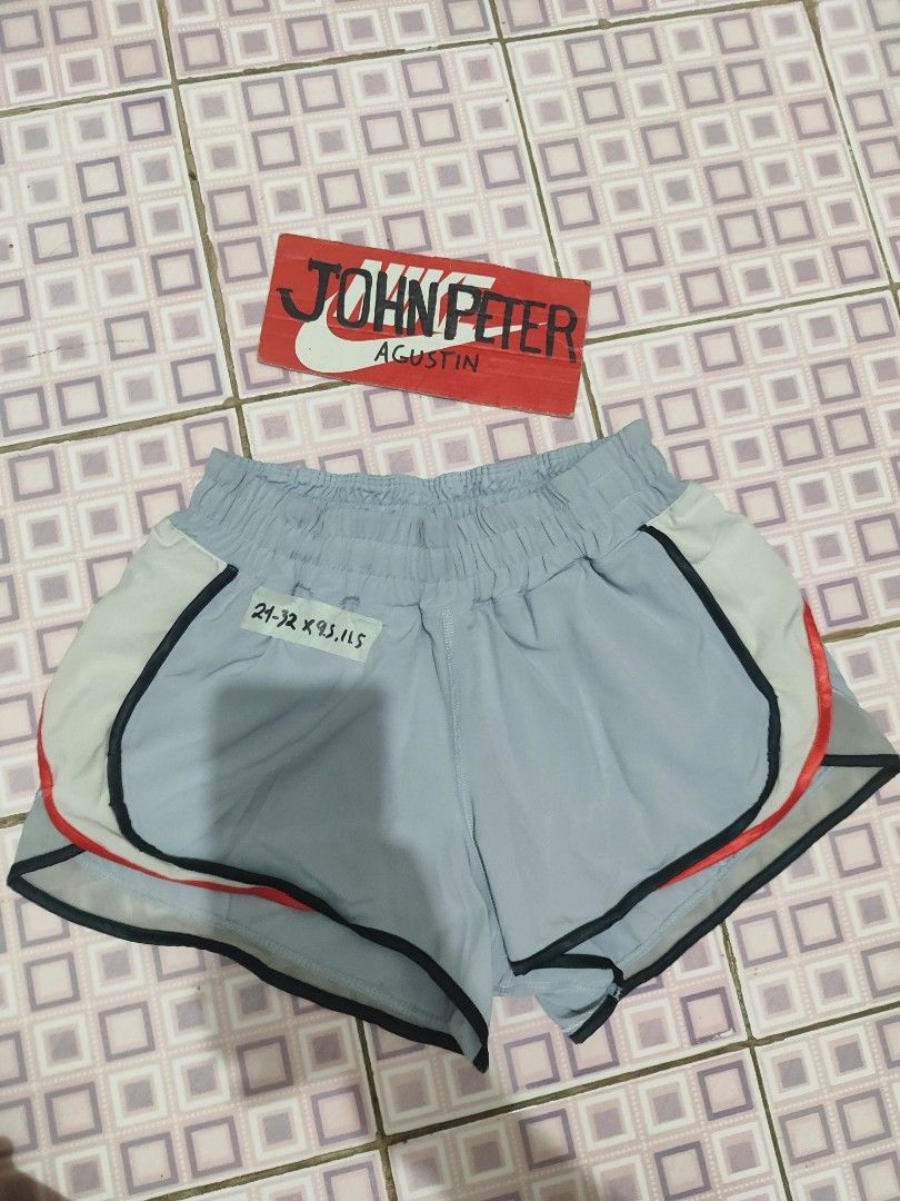 Lululemon Running Shorts Grey Blue Red Trim (Category: Activewear) located in Tuguegarao City. Submitted by johnpetera0818 (Listing ID 1450770861, Image 1). Description: - 24-32 waist 9.5 front 11.5 back Lightweight Lululemon running shorts - Color: Grey with blue and red trim details - Features an elastic waistband - Includes a small zippered pocket on the back - Built-in liner for comfort and support - Ideal for running, workouts, or everyday c